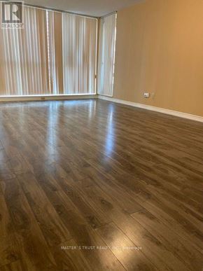 Toronto (Bay Street Corridor) condo for rent - A room with wooden flooring and a window with curtains.