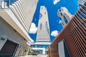 Vaughan (Vaughan Corporate Centre) condo for rent - A cityscape with tall buildings and a clear blue sky.