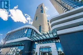 Vaughan (Vaughan Corporate Centre) condo for rent - A modern building with a curved glass facade and a sign that reads "215-195 Commerce.".