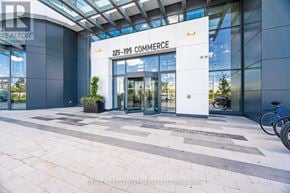 Vaughan (Vaughan Corporate Centre) condo for rent - The entrance to a building with a glass facade and a sign that reads "225-195 Commerce".