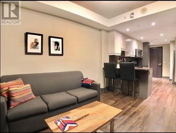 Waterloo condo for rent - A living room with a grey couch and a coffee table.