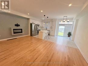Pickering townhouse for rent - A spacious kitchen with wooden flooring and a refrigerator.