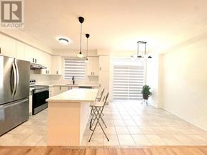 Pickering townhouse for rent - A kitchen with a refrigerator, oven, and sink.