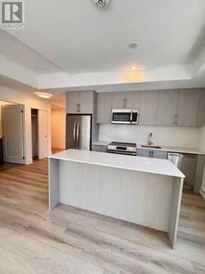 Toronto (Yonge-Eglinton) condo for rent - A modern kitchen with a white countertop and wooden flooring.