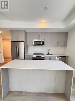Toronto (Yonge-Eglinton) condo for rent - A modern kitchen with a white island in the middle.
