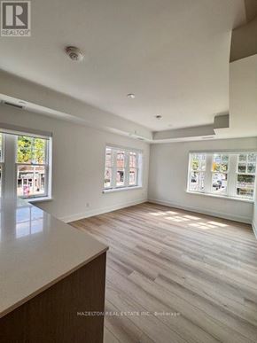 Toronto (Yonge-Eglinton) condo for rent - A real estate listing image of a room with wood flooring and white walls.