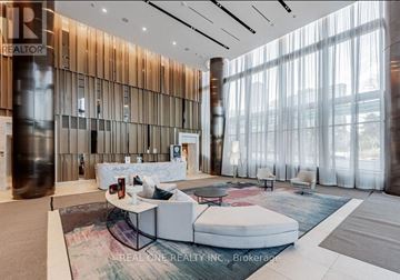 Toronto (North St. James Town) condo for rent - A modern living room with a white sofa set and a glass wall.
