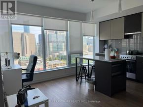 Toronto (Kensington-Chinatown) condo for rent - A modern kitchen with a view of the cityscape outside the window.