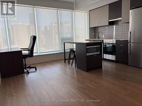 Toronto (Kensington-Chinatown) condo for rent - A modern kitchen with a view of the city.