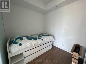 Toronto (Kensington-Chinatown) condo for rent - A bedroom with a bed, nightstands and a dresser.