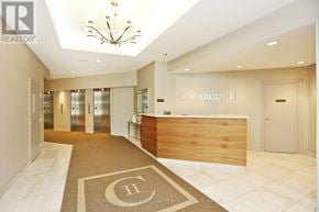 Toronto (Rouge) condo for rent - A reception area with a wooden desk and a chandelier.