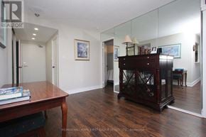 Toronto (Rouge) condo for rent - A room with a wooden floor and a wooden table with a book on it.