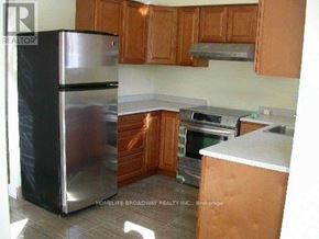 Mississauga (East Credit) apartment for rent - A kitchen with wooden cabinets and a stainless steel refrigerator.
