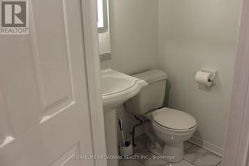 Mississauga (East Credit) apartment for rent - A kitchen with wooden cabinets and a stainless steel refrigerator.