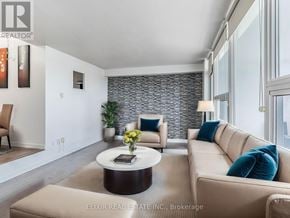 Toronto (Parkwoods-Donalda) condo for rent - A modern living room with a stone wall and a large window.