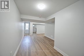 Ajax (Northwest Ajax) apartment for rent - A spacious room with wooden flooring and white walls.