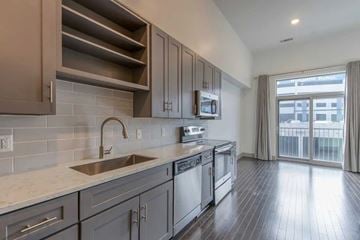 Nashville apartment for rent - A modern kitchen with dark wood floors and a stainless steel sink.
