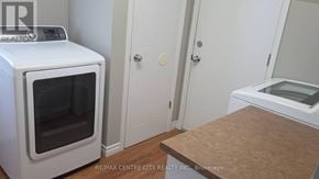 London North (North I) apartment for rent - A white microwave oven is on the left in a kitchen with a wooden counter.