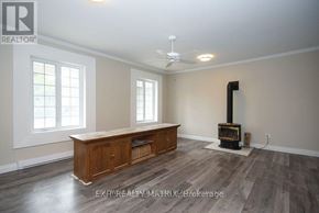 Ottawa duplex for rent - A room with wood flooring and a wood stove in it.