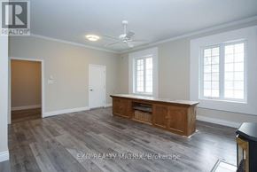Ottawa duplex for rent - A room with a wooden floor and a ceiling fan.