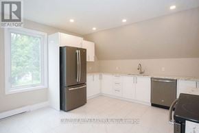 Ottawa duplex for rent - A kitchen with a refrigerator, dishwasher, and oven.