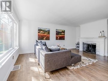 Burlington (Lasalle) apartment for rent - A living room with a grey couch and a fireplace.