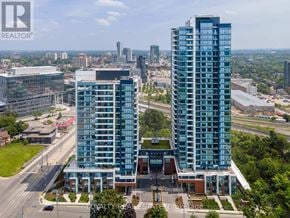 Kitchener condo for rent - Two tall buildings are situated in front of a cityscape.