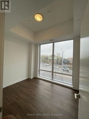 Kitchener condo for rent - A room with a window overlooking a parking lot.