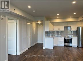 Niagara Falls (Hospital) condo for rent - A well-lit kitchen with white cabinets and stainless steel appliances.