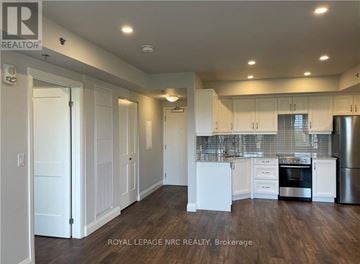 Niagara Falls (Hospital) condo for rent - A well-lit kitchen with white cabinets and stainless steel appliances.