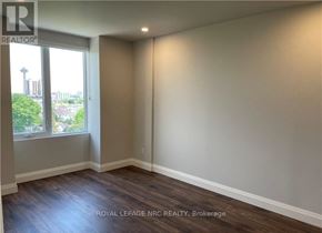 Niagara Falls (Hospital) condo for rent - A room with a window and wooden flooring.