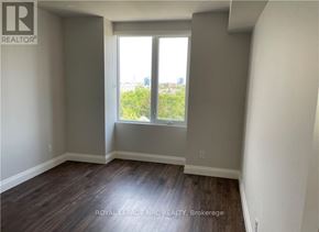 Niagara Falls (Hospital) condo for rent - A room with a large window and wooden flooring.