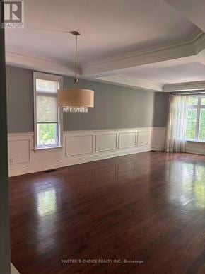 Toronto (Willowdale East) apartment for rent - A room with wooden floors and a chandelier hanging from the ceiling.