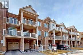 Brampton (Northwest Brampton) townhouse for rent - A building with multiple balconies and a car parked in front.