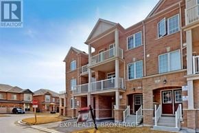 Brampton (Northwest Brampton) townhouse for rent - A building with the sign "EXR REALTY BROKERAGE" in front of it.