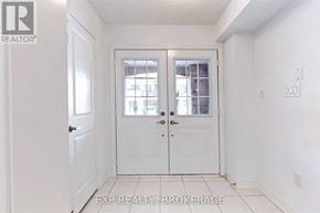 Brampton (Northwest Brampton) townhouse for rent - A white door with a glass window is in the middle of a room.