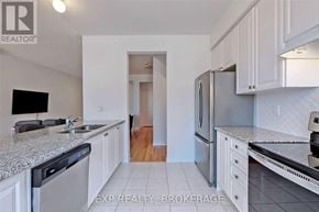 Brampton (Northwest Brampton) townhouse for rent - A kitchen with white cabinets and a granite countertop.