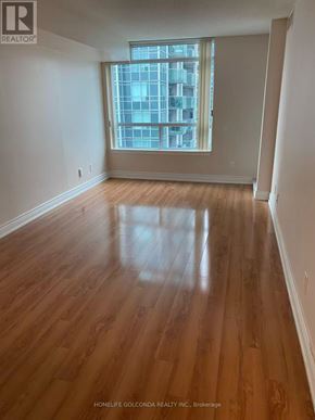 Toronto (Willowdale East) condo for rent - A room with wooden flooring and a large window.