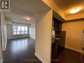 Toronto (Etobicoke West Mall) condo for rent - A kitchen area with a sink and a refrigerator.