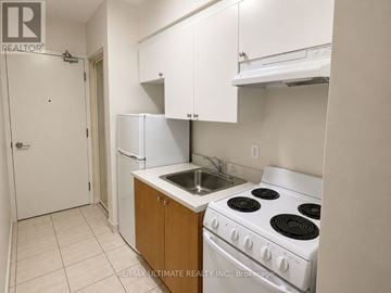 Toronto (Church-Yonge Corridor) condo for rent - A kitchen with white appliances and cabinets.