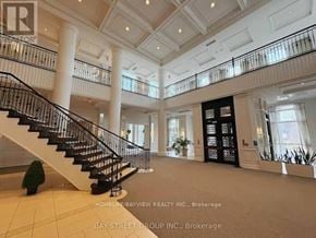 Toronto (Newtonbrook West) condo for rent - A large, well-lit foyer with a staircase and a black railing.