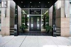 Toronto (Annex) condo for rent - The front of a building with a glass door and a sign that says "The Towers".