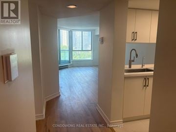 Toronto (Bay Street Corridor) condo for rent - A kitchen area with white cabinets and a sink.
