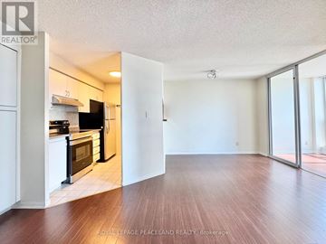 Toronto (Bay Street Corridor) condo for rent - A kitchen with white cabinets and black appliances is shown.