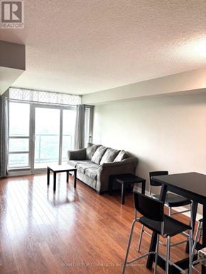 Toronto (Tam O'shanter-Sullivan) condo for rent - A living room with a couch, chair, and table.