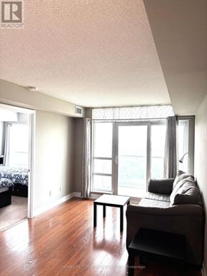 Toronto (Tam O'shanter-Sullivan) condo for rent - A living room with a couch, a table, and a window.