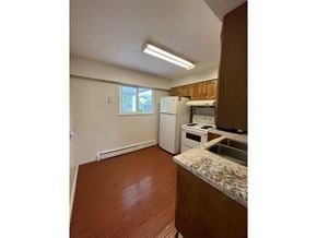 Surrey apartment for rent - A kitchen with a sink, stove, and refrigerator.