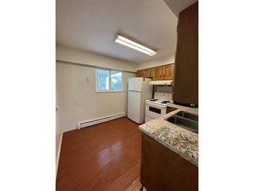 Surrey apartment for rent - A kitchen with a sink, stove, and refrigerator.