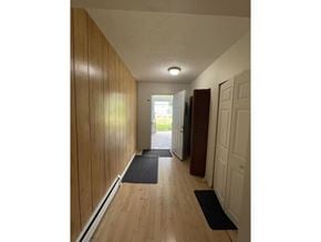 Surrey apartment for rent - A hallway with wooden walls and a black mat on the floor.