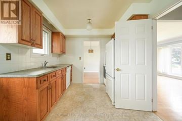 Oakville (Br Bronte) apartment for rent - A kitchen with wooden cabinets and a white door.